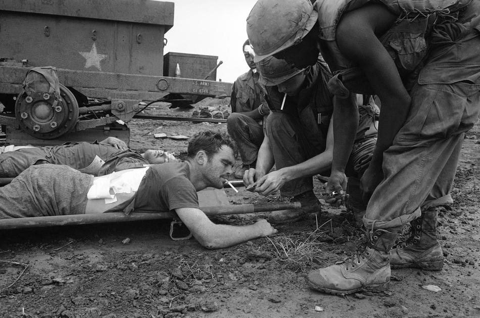 A medic lights a cigarette for Spec/5 Gary Davies of Scranton, Pa ...